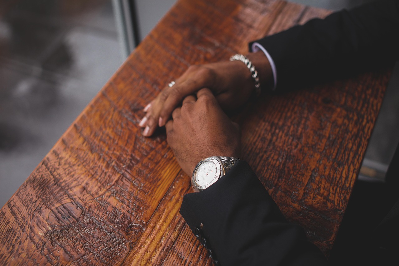 Business, hands, wristwatch — Navigating the Challenges of Asbestos Survey in Historic Buildings